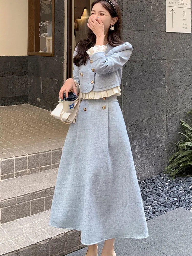 a woman wearing a blue dress and white shoes